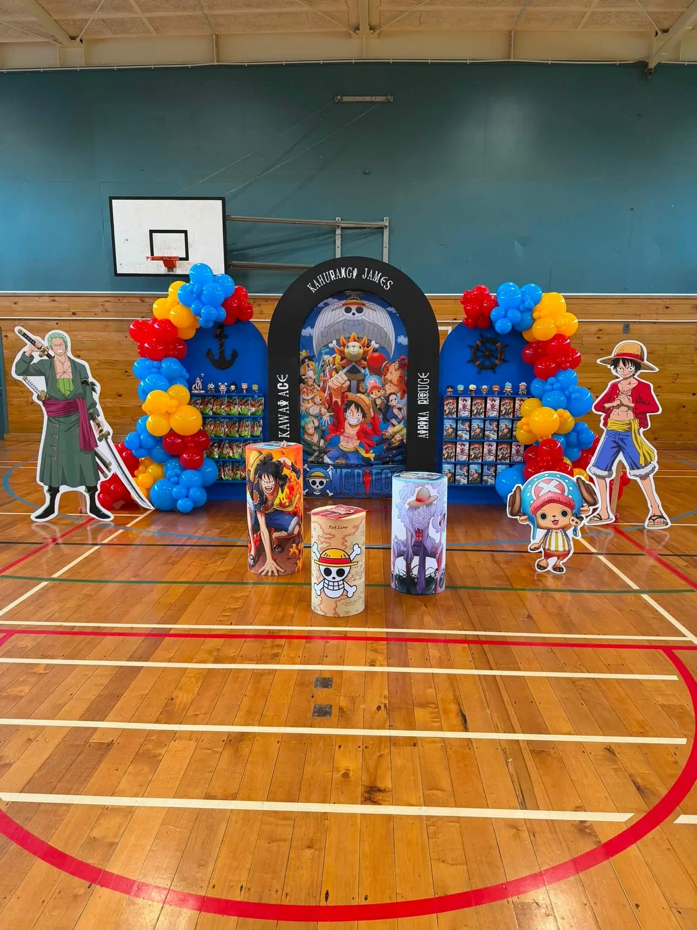 Colourful milestone party setup with arches, balloon garlands and themed props